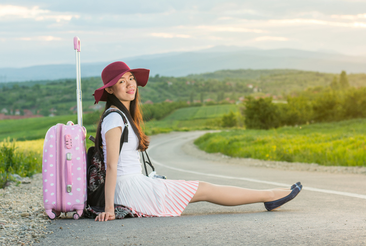 Lonely girl sitting on the road